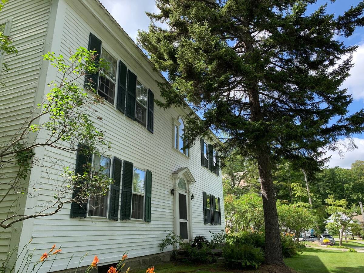 The inn in summer, daylilies along the south wall